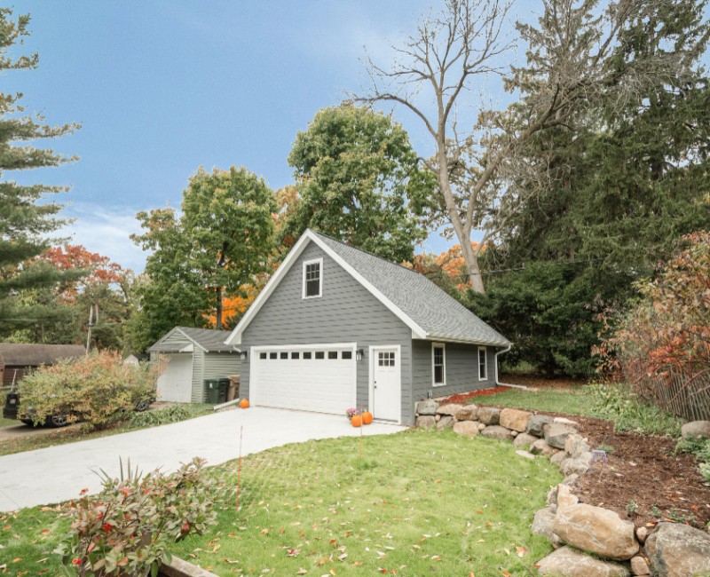Demolition of an old, rotting garage and construction of a spacious two-car garage addition with room for both vehicles.