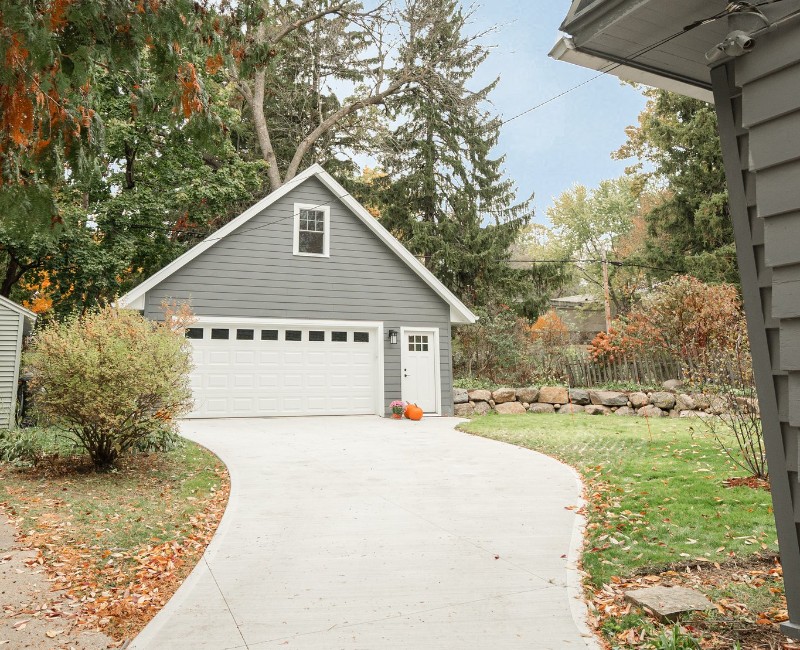 Demolition of an old, rotting garage and construction of a spacious two-car garage addition with room for both vehicles.
