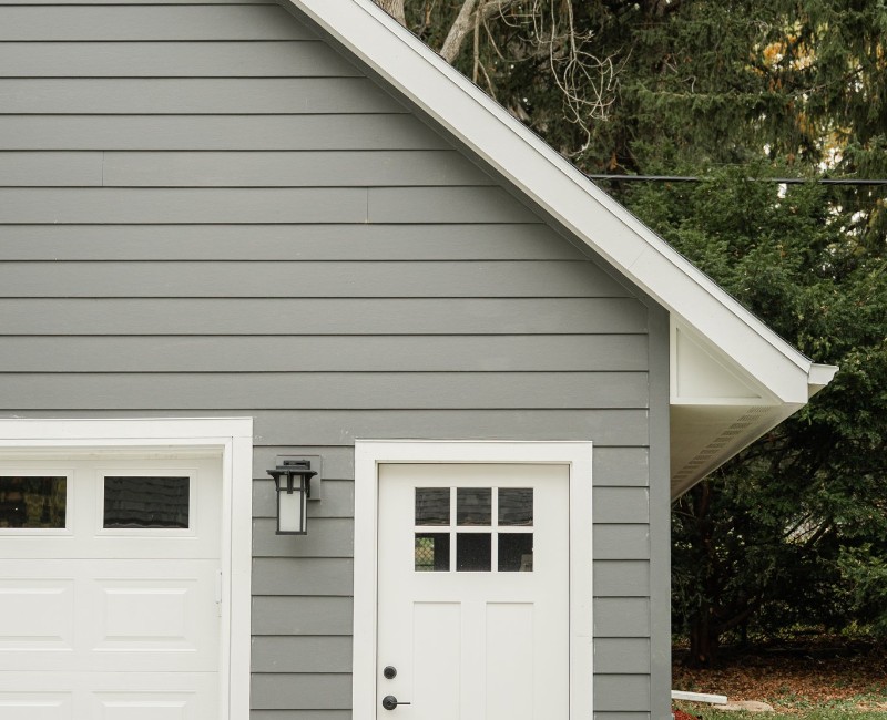 Demolition of an old, rotting garage and construction of a spacious two-car garage addition with room for both vehicles.