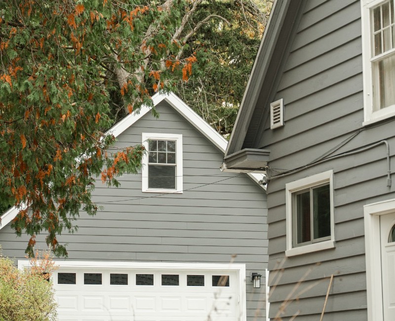 Demolition of an old, rotting garage and construction of a spacious two-car garage addition with room for both vehicles.