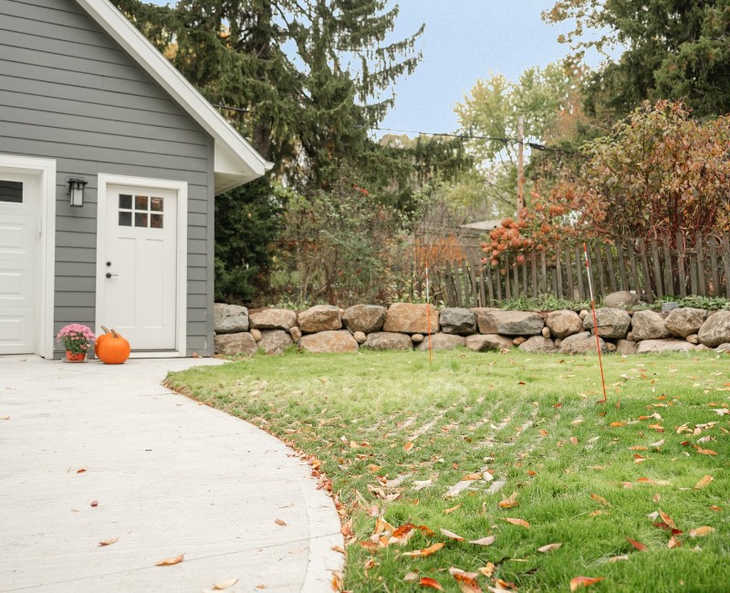 Demolition of an old, rotting garage and construction of a spacious two-car garage addition with room for both vehicles.