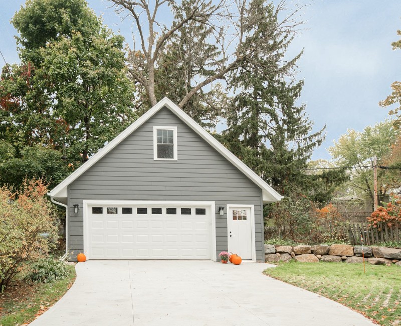 Demolition of an old, rotting garage and construction of a spacious two-car garage addition with room for both vehicles.