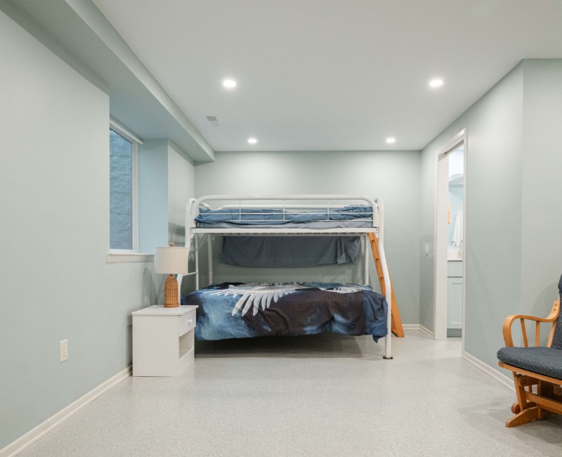 A basement remodel in Madison, WI that transformed an unfinished basement into a rec room, complete with a private full bath. The layout gives the kids a place that’s entirely their own: room to run around, play with toys, and sleep. 