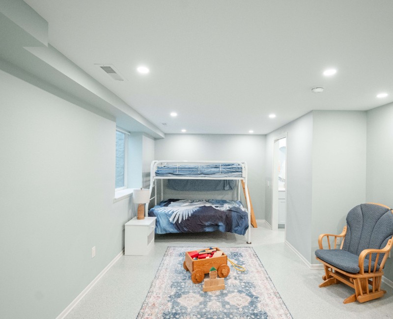 A basement remodel in Madison, WI that transformed an unfinished basement into a rec room, complete with a private full bath. The layout gives the kids a place that’s entirely their own: room to run around, play with toys, and sleep. 