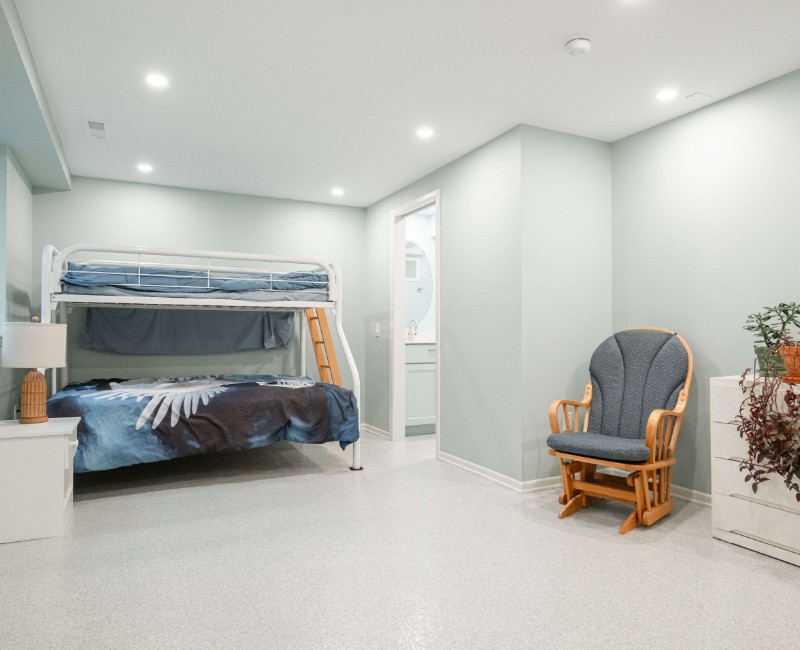 A basement remodel in Madison, WI that transformed an unfinished basement into a rec room, complete with a private full bath. The layout gives the kids a place that’s entirely their own: room to run around, play with toys, and sleep. 