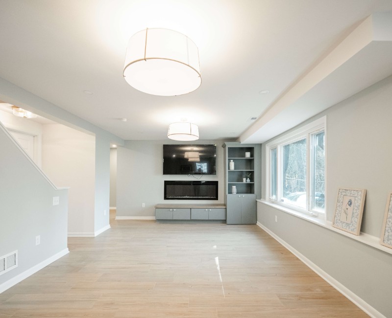 This basement remodel was part of a full basement and kitchen renovation in Madison, WI. Our design-build team transformed an outdated basement into a spacious rec room with wet bar and fridge, a den or office area, and a full bathroom. 