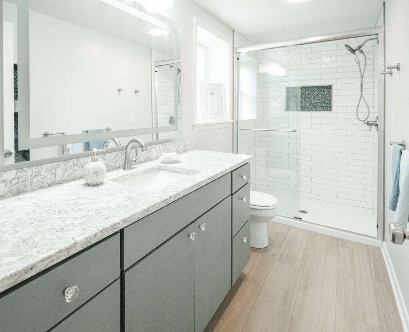This basement remodel was part of a full basement and kitchen renovation in Madison, WI. Our design-build team transformed an outdated basement into a spacious rec room with wet bar and fridge, a den or office area, and a full bathroom. 