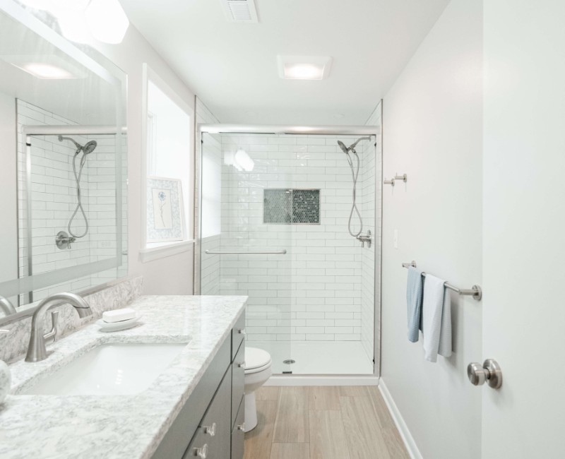 This basement remodel was part of a full basement and kitchen renovation in Madison, WI. Our design-build team transformed an outdated basement into a spacious rec room with wet bar and fridge, a den or office area, and a full bathroom. 