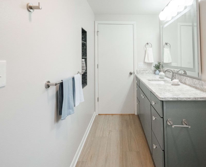 This basement remodel was part of a full basement and kitchen renovation in Madison, WI. Our design-build team transformed an outdated basement into a spacious rec room with wet bar and fridge, a den or office area, and a full bathroom. 