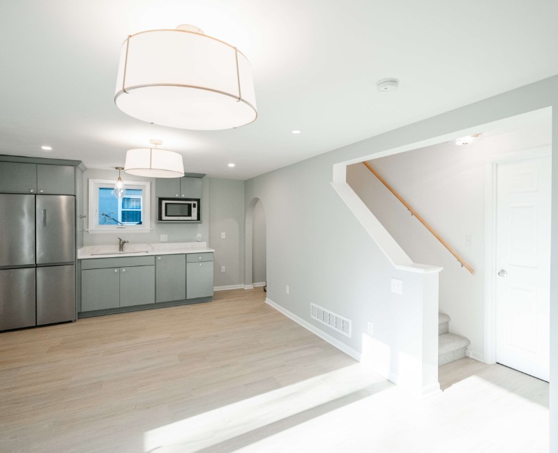 This basement remodel was part of a full basement and kitchen renovation in Madison, WI. Our design-build team transformed an outdated basement into a spacious rec room with wet bar and fridge, a den or office area, and a full bathroom. 