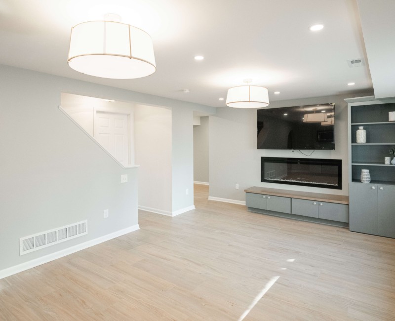 This basement remodel was part of a full basement and kitchen renovation in Madison, WI. Our design-build team transformed an outdated basement into a spacious rec room with wet bar and fridge, a den or office area, and a full bathroom. 