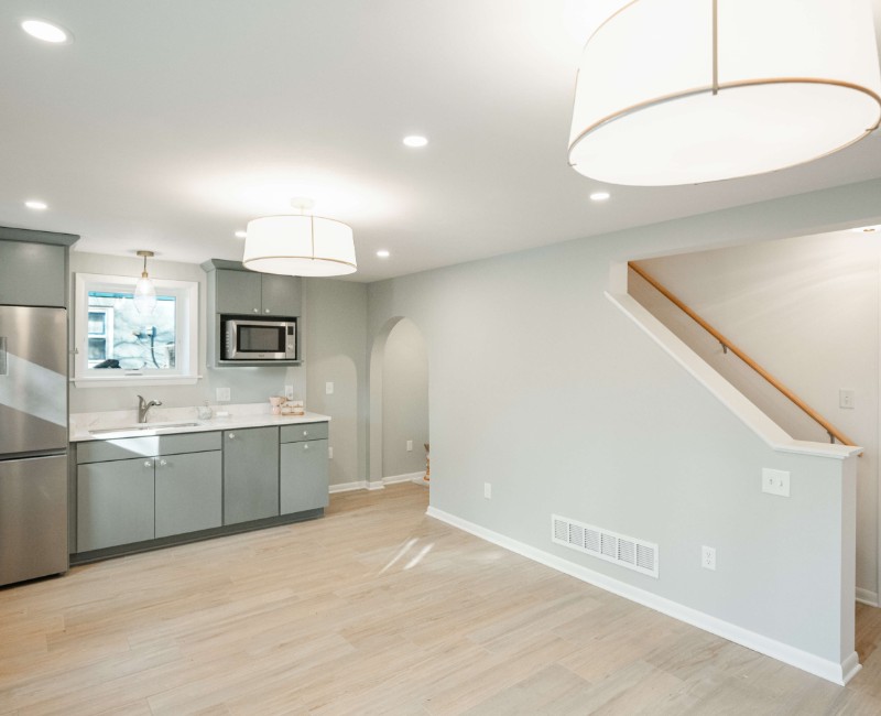 This basement remodel was part of a full basement and kitchen renovation in Madison, WI. Our design-build team transformed an outdated basement into a spacious rec room with wet bar and fridge, a den or office area, and a full bathroom. 