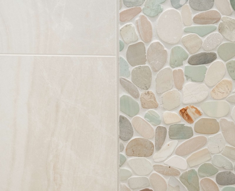 This bathroom renovation in a home on Madison's west side was part of a complete kitchen and bath remodel. In the primary bathroom, we removed the original tub and replaced it with a custom walk-in shower. The shower is hassle-free and easy to clean with no door or curtain. 