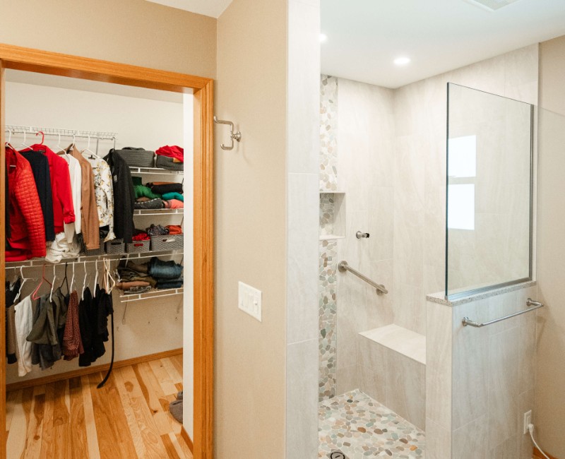 This bathroom renovation in a home on Madison's west side was part of a complete kitchen and bath remodel. In the primary bathroom, we removed the original tub and replaced it with a custom walk-in shower. The shower is hassle-free and easy to clean with no door or curtain. 