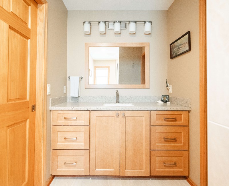 This bathroom renovation in a home on Madison's west side was part of a complete kitchen and bath remodel. In the primary bathroom, we removed the original tub and replaced it with a custom walk-in shower. The shower is hassle-free and easy to clean with no door or curtain. 