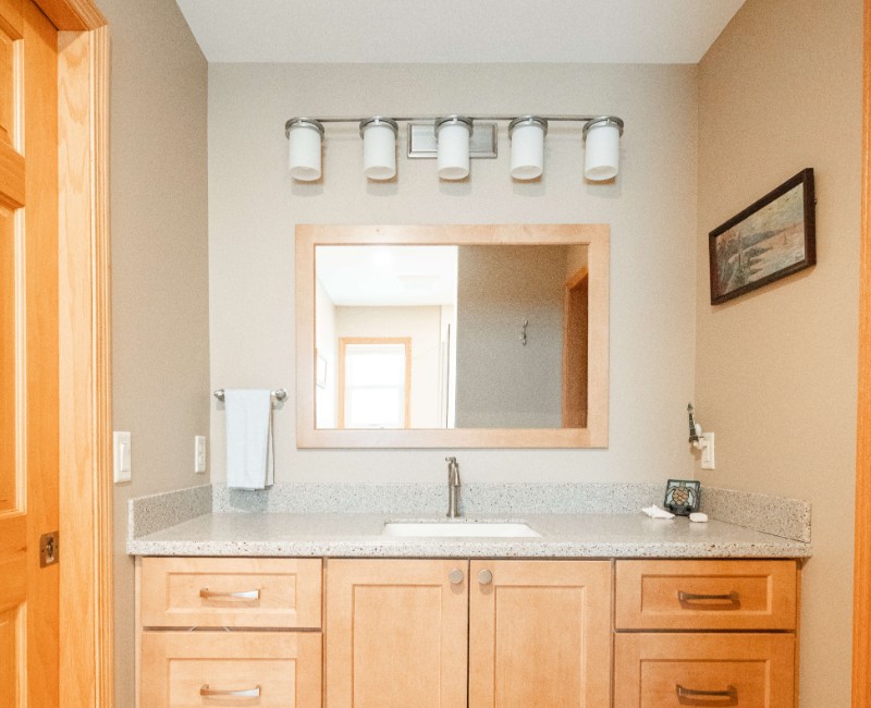 This bathroom renovation in a home on Madison's west side was part of a complete kitchen and bath remodel. In the primary bathroom, we removed the original tub and replaced it with a custom walk-in shower. The shower is hassle-free and easy to clean with no door or curtain. 