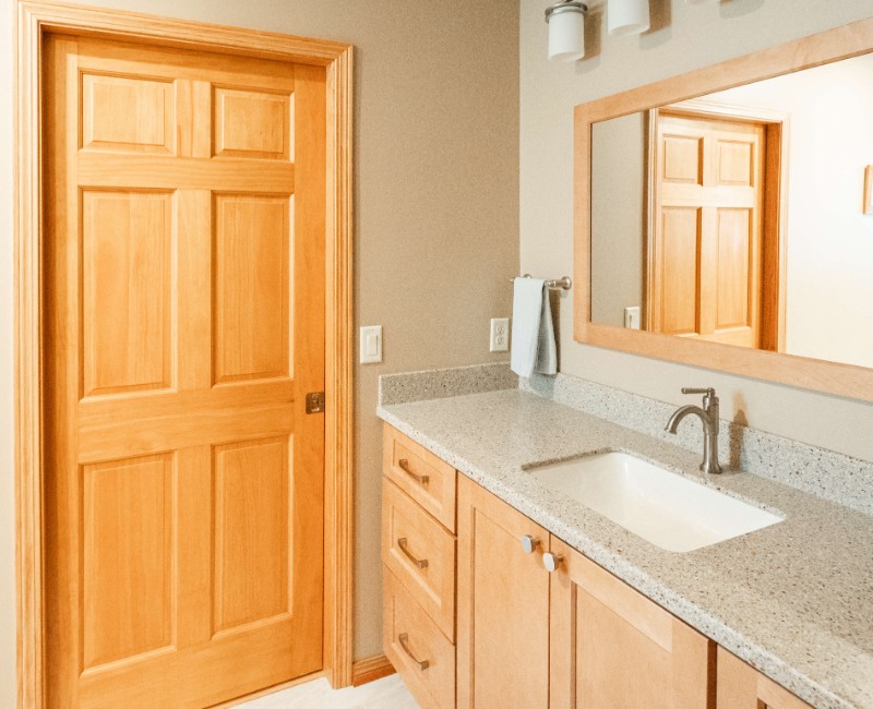 This bathroom renovation in a home on Madison's west side was part of a complete kitchen and bath remodel. In the primary bathroom, we removed the original tub and replaced it with a custom walk-in shower. The shower is hassle-free and easy to clean with no door or curtain. 