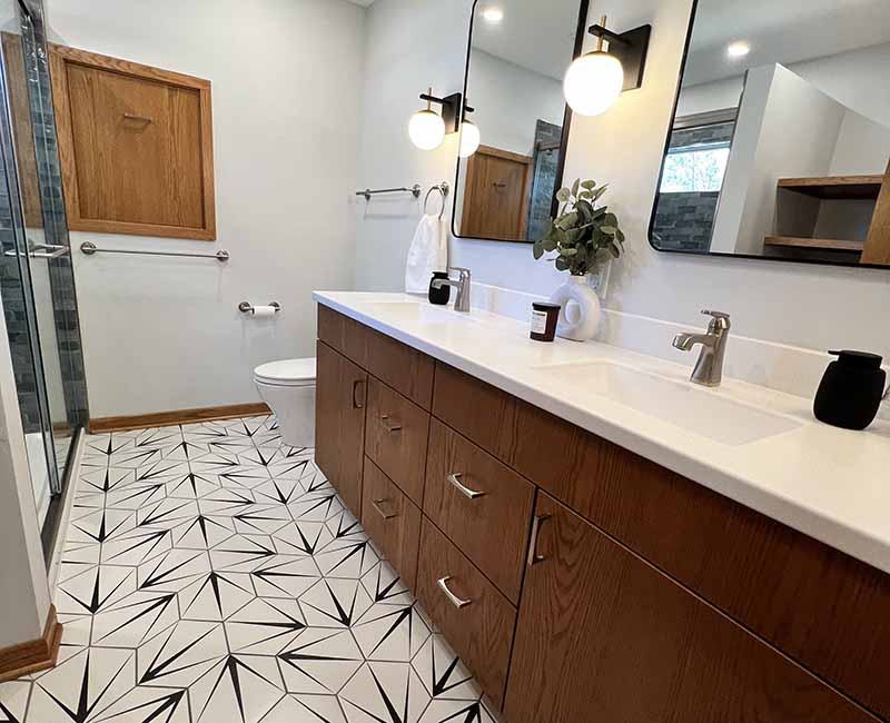 We kept the mid-century modern vibe alive in this two-bathroom remodel in Madison, WI.