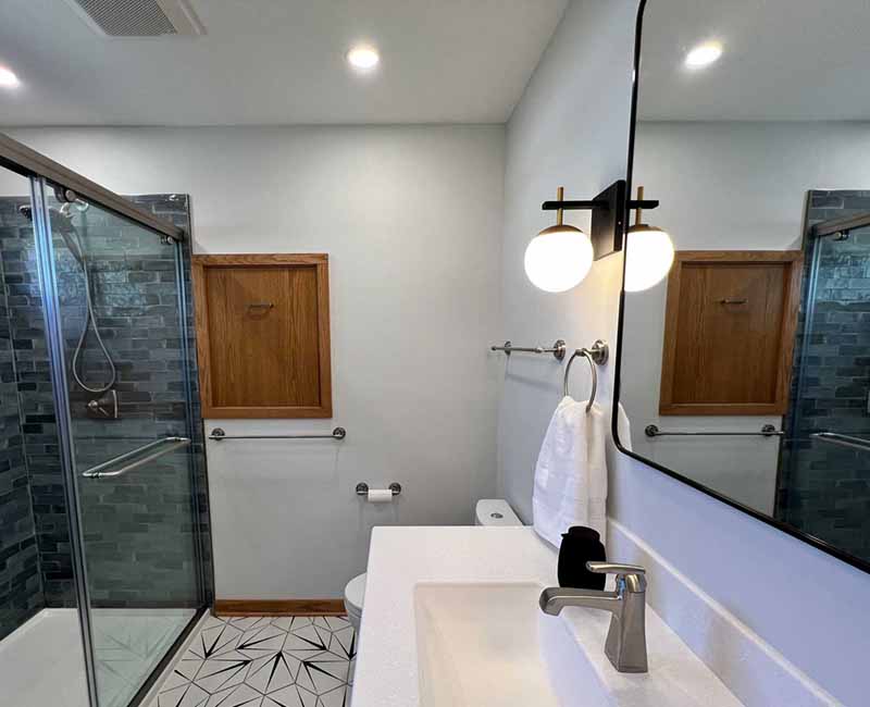 We kept the mid-century modern vibe alive in this two-bathroom remodel in Madison, WI.