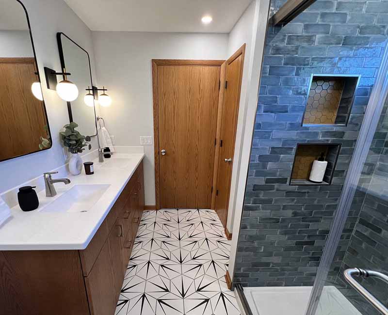 We kept the mid-century modern vibe alive in this two-bathroom remodel in Madison, WI.