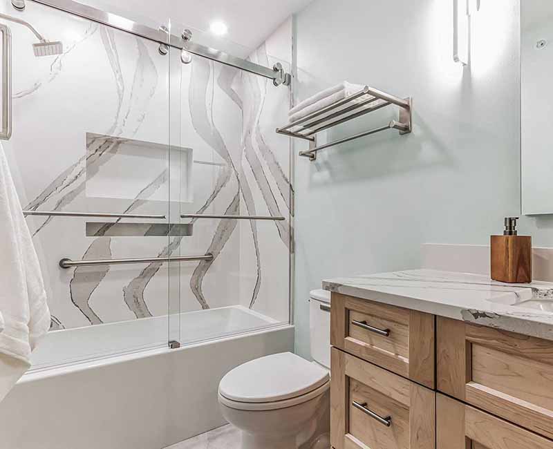 We completed a full remodel of both the primary bathroom and guest bathroom in this home in Madison, WI. Cambria quartz was used on all shower and bath walls and the tops of the bathroom vanities.