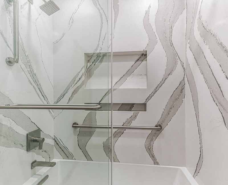 We completed a full remodel of both the primary bathroom and guest bathroom in this home in Madison, WI. Cambria quartz was used on all shower and bath walls and the tops of the bathroom vanities.