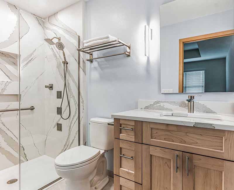 We completed a full remodel of both the primary bathroom and guest bathroom in this home in Madison, WI. Cambria quartz was used on all shower and bath walls and the tops of the bathroom vanities.