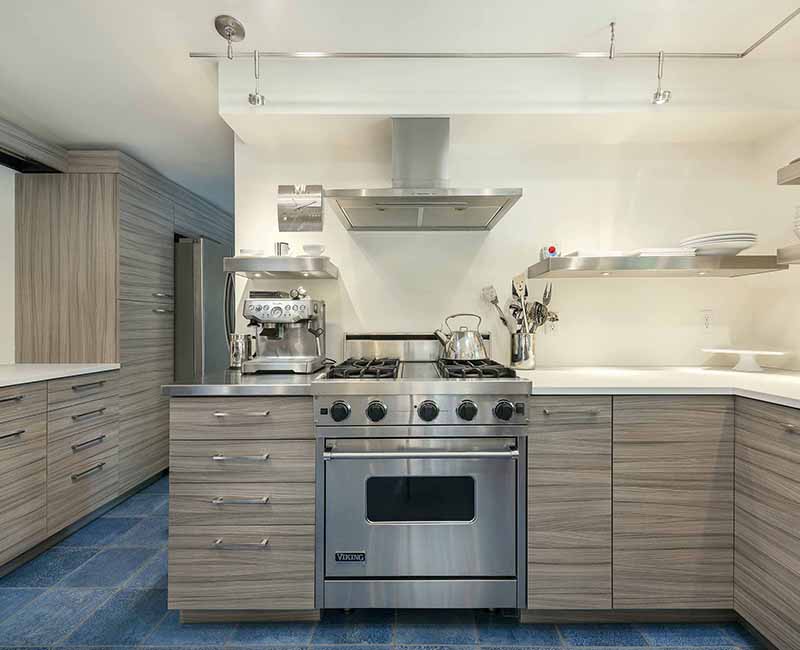 We remodeled the kitchen in this mid-century modern home in Madison, WI to showcase the homeowner's love for food, art, and architecture. It features a Viking Professional freestanding range oven and a Zephyr range hood so the homeowner can bake and cook as well at their home as at their restaurant.