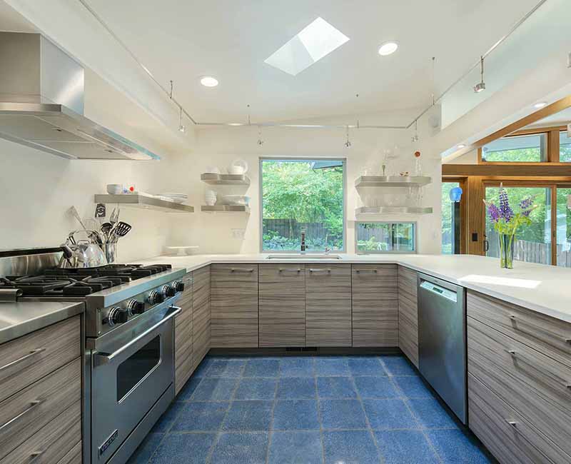 We remodeled the kitchen in this mid-century modern home in Madison, WI to showcase the homeowner's love for food, art, and architecture. It features a Viking Professional freestanding range oven and a Zephyr range hood so the homeowner can bake and cook as well at their home as at their restaurant.