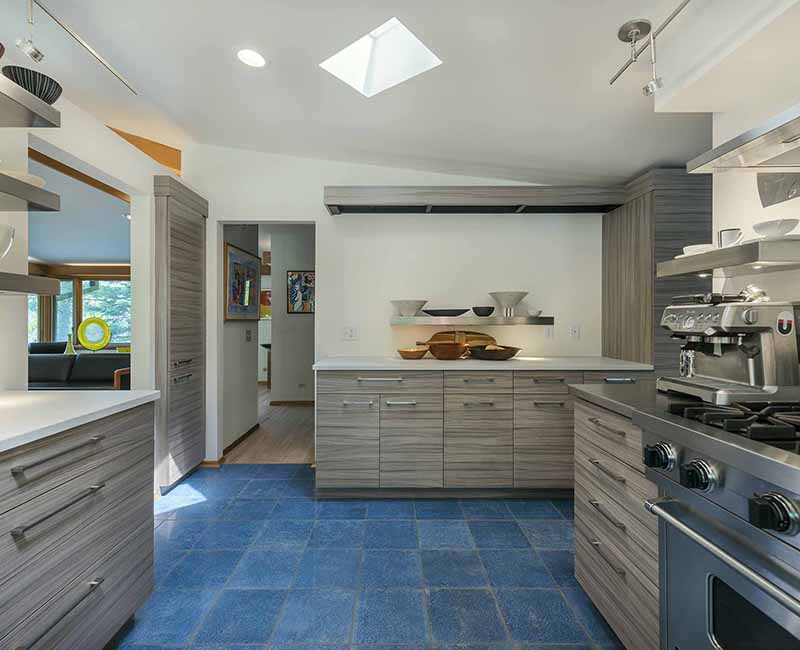 We remodeled the kitchen in this mid-century modern home in Madison, WI to showcase the homeowner's love for food, art, and architecture. It features a Viking Professional freestanding range oven and a Zephyr range hood so the homeowner can bake and cook as well at their home as at their restaurant.