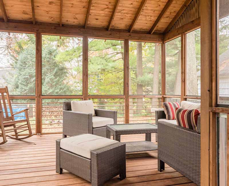 We added a covered porch, a spacious deck, and a breezeway to this home in Madison, WI. The homeowners now have an outdoor space shielded from weather and mosquitos.