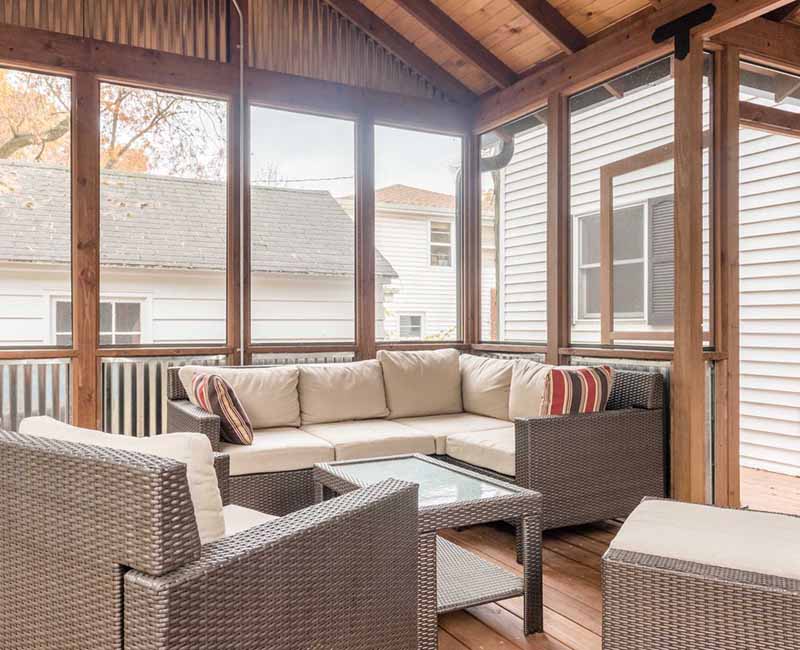 We added a covered porch, a spacious deck, and a breezeway to this home in Madison, WI. The homeowners now have an outdoor space shielded from weather and mosquitos.