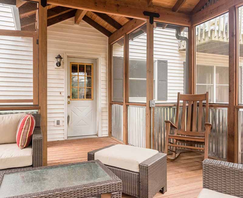 We added a covered porch, a spacious deck, and a breezeway to this home in Madison, WI. The homeowners now have an outdoor space shielded from weather and mosquitos.