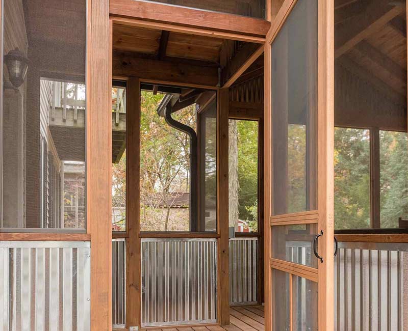 We added a covered porch, a spacious deck, and a breezeway to this home in Madison, WI. The homeowners now have an outdoor space shielded from weather and mosquitos.