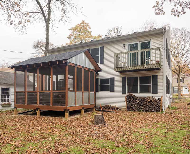 We added a covered porch, a spacious deck, and a breezeway to this home in Madison, WI. The homeowners now have an outdoor space shielded from weather and mosquitos.
