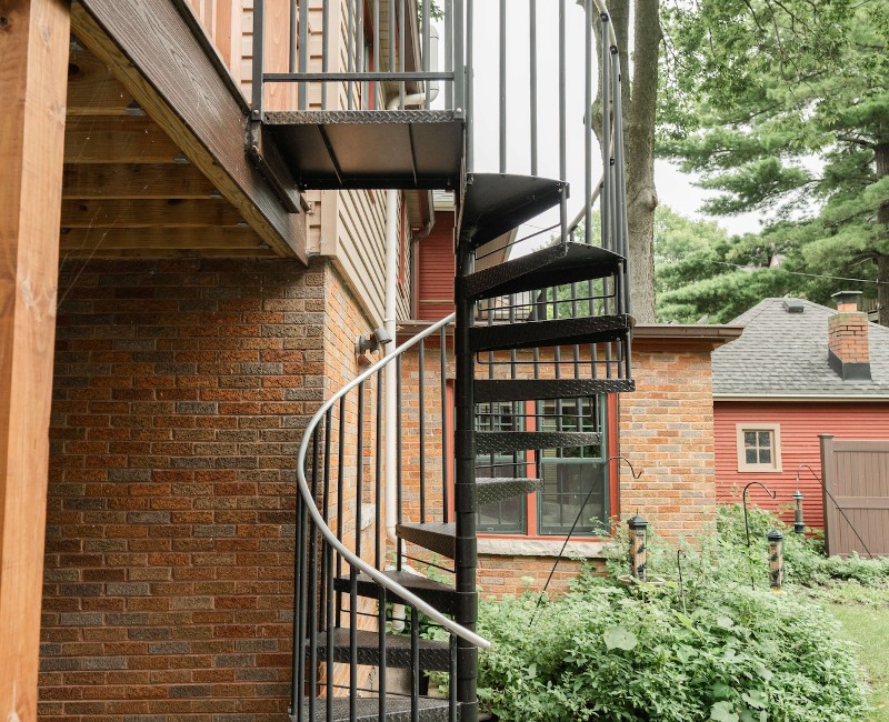 A screened-in porch addition for a historic Madison, WI home. We built a durable screened-in porch for shaded outdoor living; an open, sunny side deck; and a spiral staircase for backyard access. 
