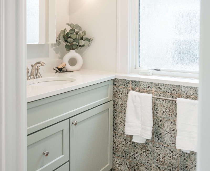 What began as a cold, drafty enclosed porch is now one of the homeowners’ favorite rooms. A bright, energy-efficient sunroom with a beautifully integrated first-floor bathroom. 