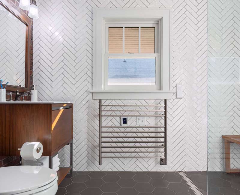 For this 100-year-old farmhouse in Mt. Horeb, WI, we remodeled the primary bathroom, kitchen, mudroom, and entryway. We also updated the pantry to include a built-in sliding ladder and restored the front porch.