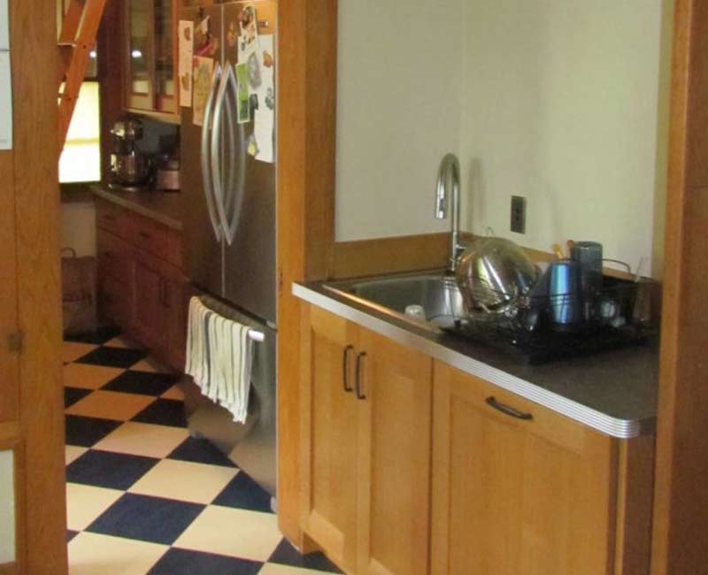 For this 100-year-old farmhouse in Mt. Horeb, WI, we remodeled the primary bathroom, kitchen, mudroom, and entryway. We also updated the pantry to include a built-in sliding ladder and restored the front porch.