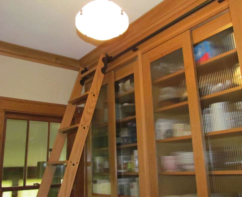For this 100-year-old farmhouse in Mt. Horeb, WI, we remodeled the primary bathroom, kitchen, mudroom, and entryway. We also updated the pantry to include a built-in sliding ladder and restored the front porch.