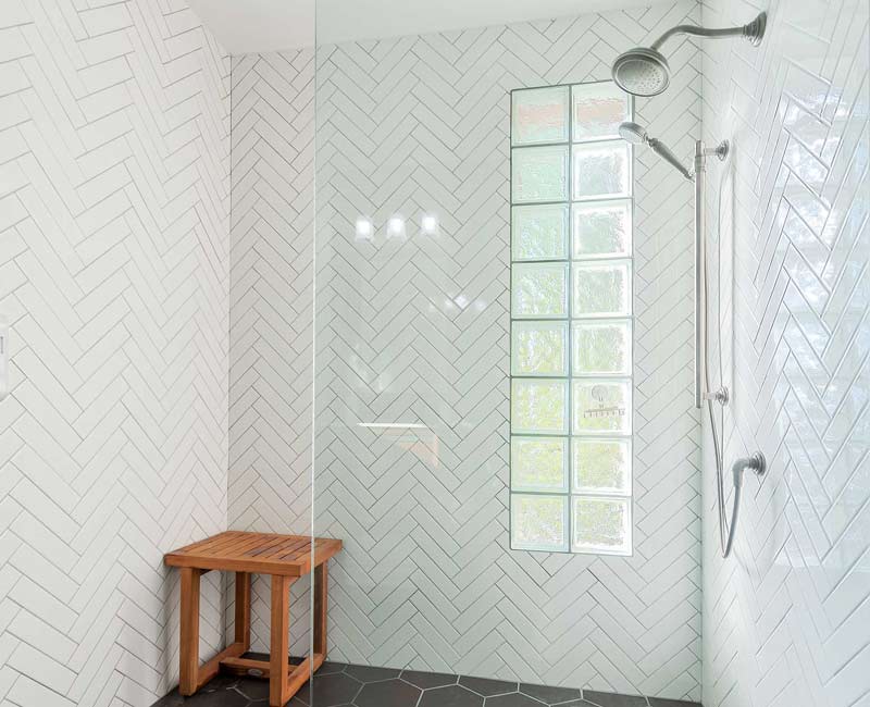 For this 100-year-old farmhouse in Mt. Horeb, WI, we remodeled the primary bathroom, kitchen, mudroom, and entryway. We also updated the pantry to include a built-in sliding ladder and restored the front porch.