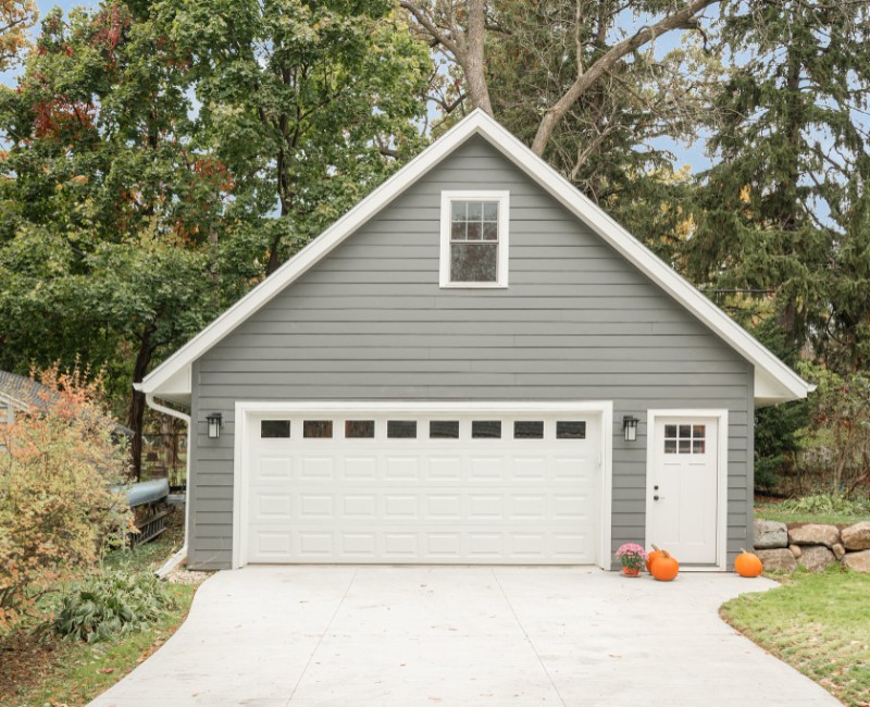 Demolition of an old, rotting garage and construction of a spacious two-car garage addition with room for both vehicles.