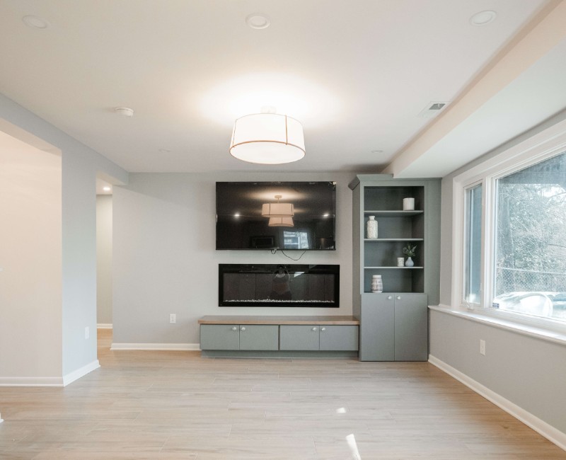 This basement remodel was part of a full basement and kitchen renovation in Madison, WI. Our design-build team transformed an outdated basement into a spacious rec room with wet bar and fridge, a den or office area, and a full bathroom. 