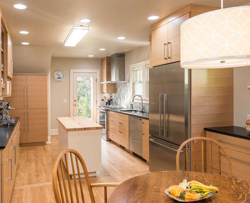 We created this bright and expansive kitchen and dining area by removing a wall and allowing light to pour into the space.